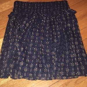 Navy miniskirt with yellow pattern.